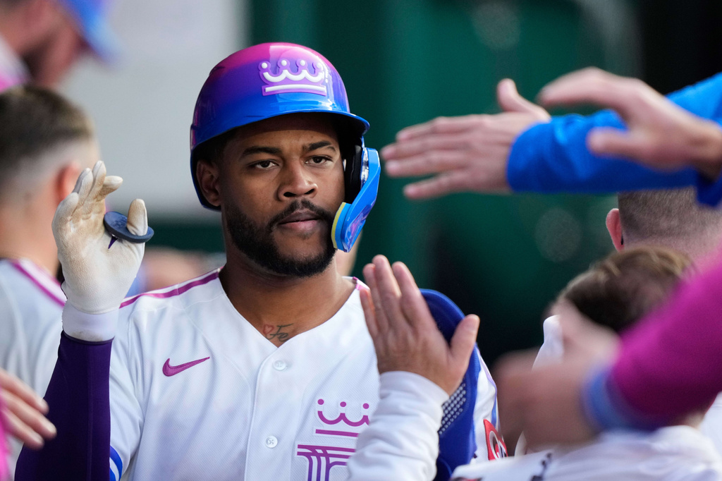 Kansas City Royals' Maikel Garcia celebrates in the dugout after scoring on a double by Bobby Witt Jr. during the fourth inning of a baseball game against the Chicago White Sox, Friday, April 10, 2026, in Kansas City, Mo. (AP Photo/Charlie Riedel)