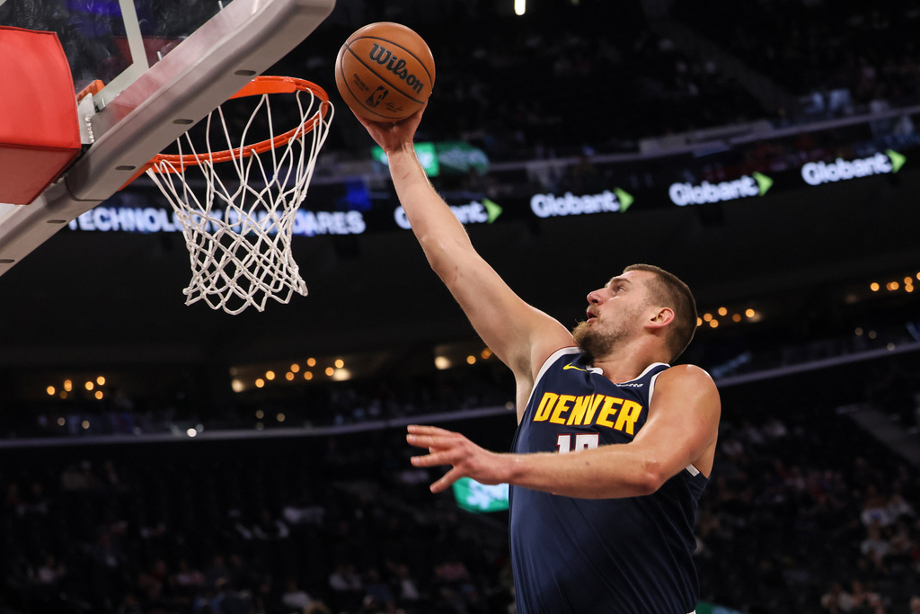 Denver Nuggets center Nikola Jokic scores during the first half of a preseason NBA basketball game against the Los Angeles Lakers, Sunday, Oct. 12, 2025, in Inglewood, Calif. (AP Photo/Etienne Laurent)