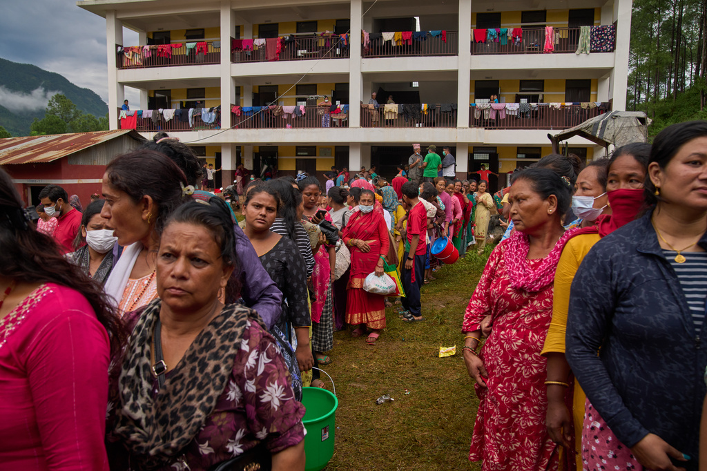 FILE - People affected by recent flash floods line up to receive aid at a school turned into a shelter in Nuwakot district, Nepal, Sept. 3, 2026. (AP Photo/Dar Yasin, File)