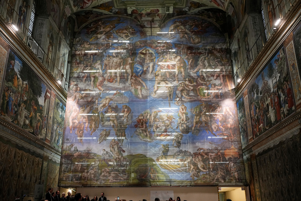 A screen with a replica of “The Last Judgment,” superimposed on it covers the scaffolding used for its extraordinary maintenance during a presentation for press in the Sistine Chapel at the Vatican, Saturday, Feb. 28, 2026. (AP Photo/Alessandra Tarantino)