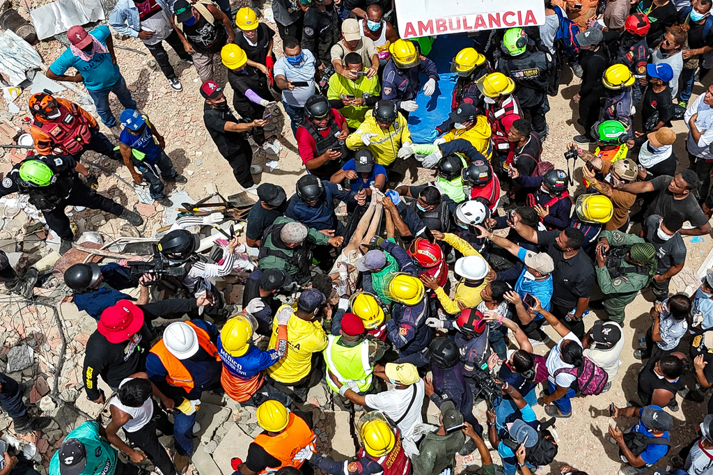 A person removed from the rubble by members of the French Civil Security Training and Intervention Regiment (UIISC 7), U.S. rescuers and others is carried on a stretcher to an ambulance along the coast in Caraballeda, La Guaira state, Venezuela, Sunday, June 28, 2026, after earthquakes. (Miguel Medina, Pool photo via AP)