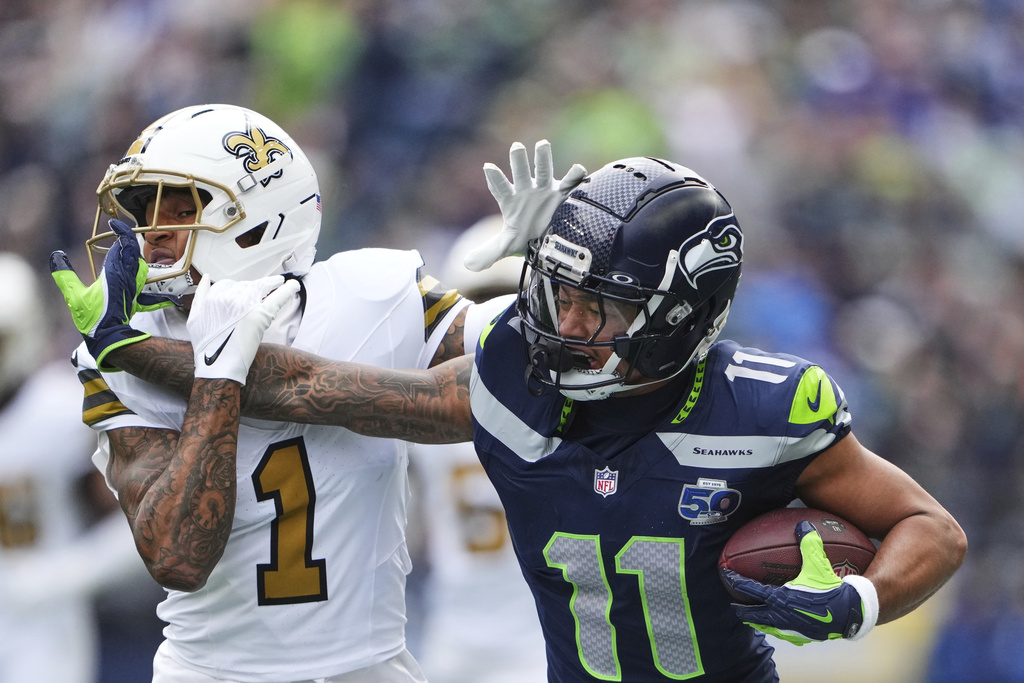 Seattle Seahawks wide receiver Jaxon Smith-Njigba (11) pulls in a pass against New Orleans Saints cornerback Alontae Taylor (1) during the first half of an NFL football game, Sunday, Sept. 21, 2025, in Seattle. (AP Photo/Lindsey Wasson)