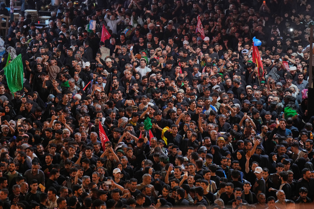 Shiite worshippers gather between the holy shrines of Imam Hussein and Imam Abbas, ahead of Arbaeen, the annual Shiite commemoration marking 40 days after Ashoura, at the Imam Hussein Shrine in Karbala, Iraq, Monday, Aug. 3, 2026. (AP Photo/Hadi Mizban)