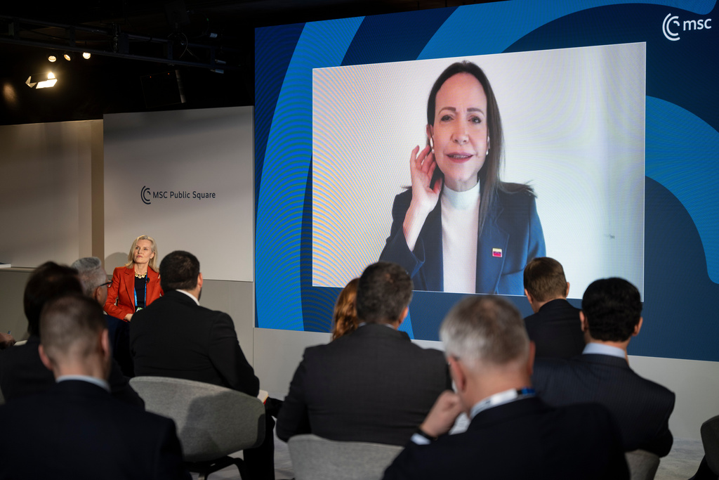 Venezuelan opposition politician María Corina Machado, on the screen, joins the Munich Security Conference in Munich, Germany, Saturday Feb. 14, 2026. (Marijan Murat/dpa via AP)