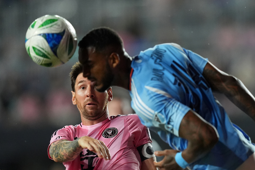Inter Miami forward Lionel Messi (10) gets beat out for a header by New York City FC defender Raul Gustavo during the first half of an MLS Eastern Conference final soccer match, Saturday, Nov. 29, 2025, in Fort Lauderdale, Fla. (AP Photo/Rebecca Blackwell)