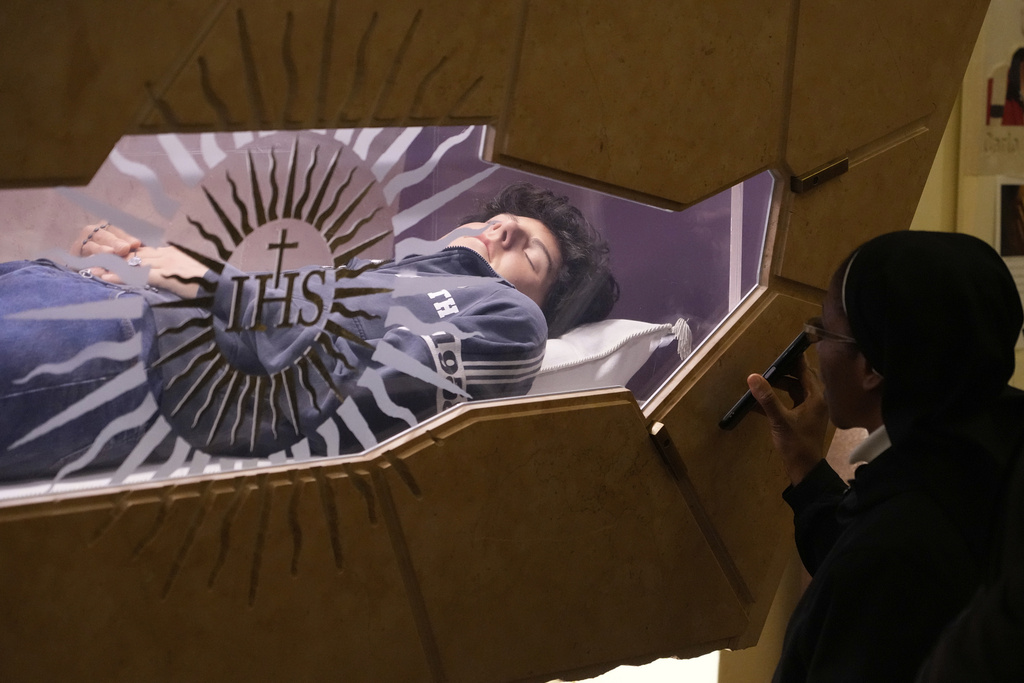FILE - The body of Carlo Acutis, an Italian boy who died in 2006 of leukemia, lies in his tomb in Assisi, Italy, March 1, 2025. (AP Photo/Gregorio Borgia, File)