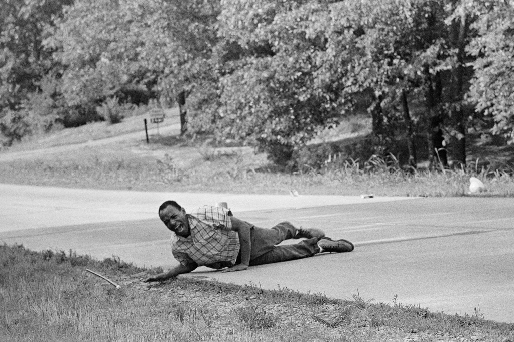 FILE - Civil rights activist James Meredith grimaces in pain as he pulls himself across Highway 51 after being shot in Hernando, Miss., June 6, 1966. (AP Photo/Jack Thornell, File)