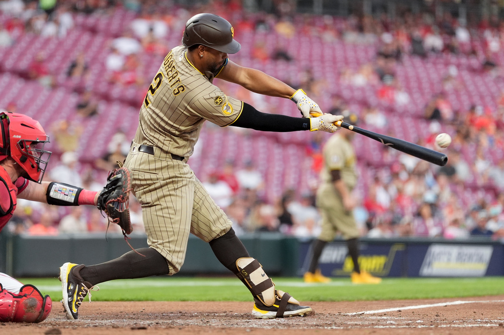 San Diego Padres' Xander Bogaerts hits a double to score Ty France, and Jackson Merrill, as Cincinnati Reds catcher Tyler Stephenson is left, during the fourth inning of a baseball game in Cincinnati, Monday, Aug. 31, 2026. (AP Photo/Carolyn Kaster)