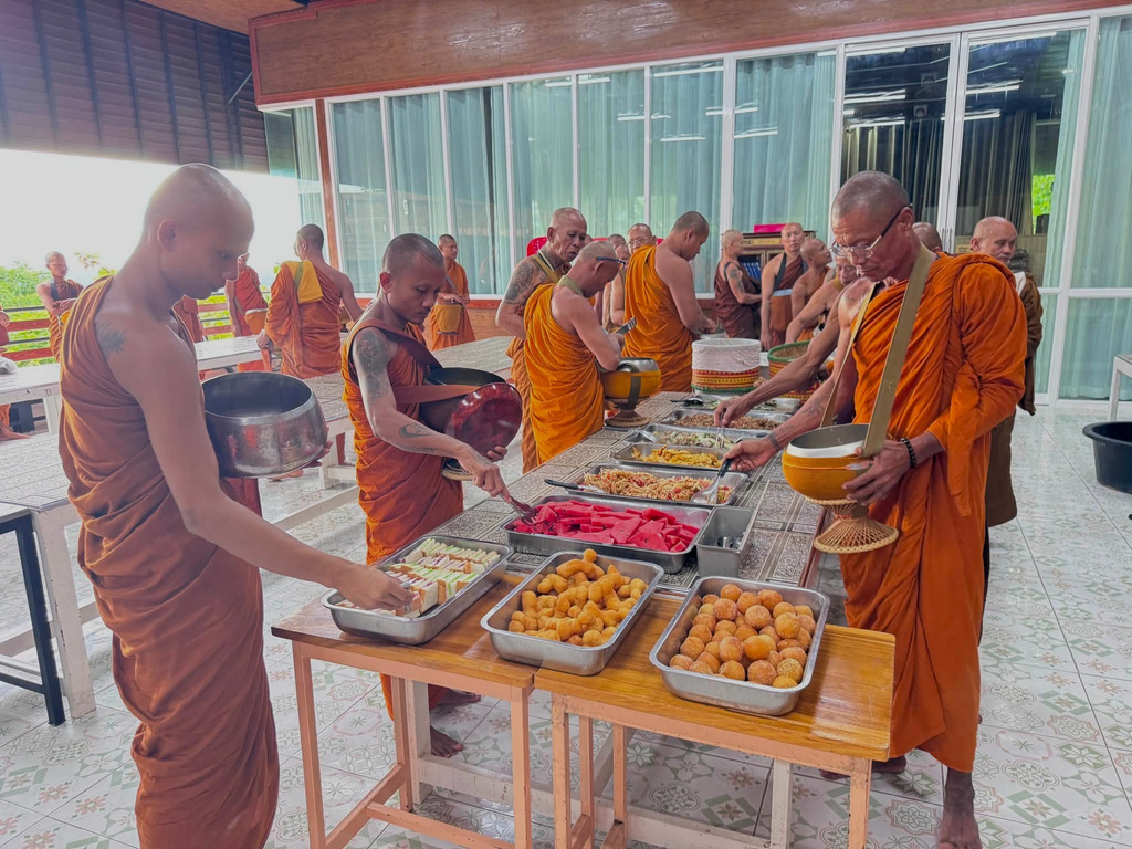 This photograph released by the Phu Manorom temple shows a group of Thai Buddhist monk picking up their food in the morning at Phu Manorom temple in Mukdahan province, Thailand, Thursday, July 2, 2026 (Phu Manorom temple via AP)