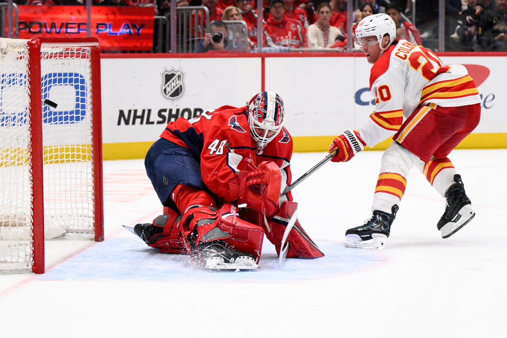 Calgary Flames left wing Blake Coleman, right, scores a goal against Washington Capitals goaltender Logan Thompson (48) during the second period of an NHL hockey game, Monday, March 9, 2026, in Washington. (AP Photo/Nick Wass)