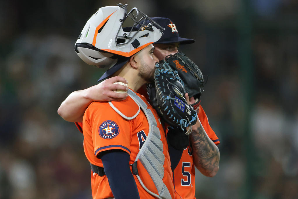 Houston Astros catcher Yainer Diaz, front, and starting pitcher Hunter Brown, behind, talk during a mound visit during the third inning of a baseball game against the Athletics, Wednesday, Sept. 24, 2025, in West Sacramento, Calif. (AP Photo/Scott Marshall)