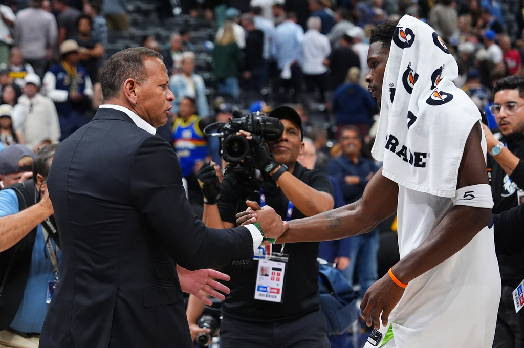 Minnesota Timberwolves guard Anthony Edwards (5) shakes hands with owner Alex Rodriguez after defending the Denver Nuggets in Game 2 of a first-round NBA playoffs basketball series Monday, April 20, 2026, in Denver. (AP Photo/Jack Dempsey)
