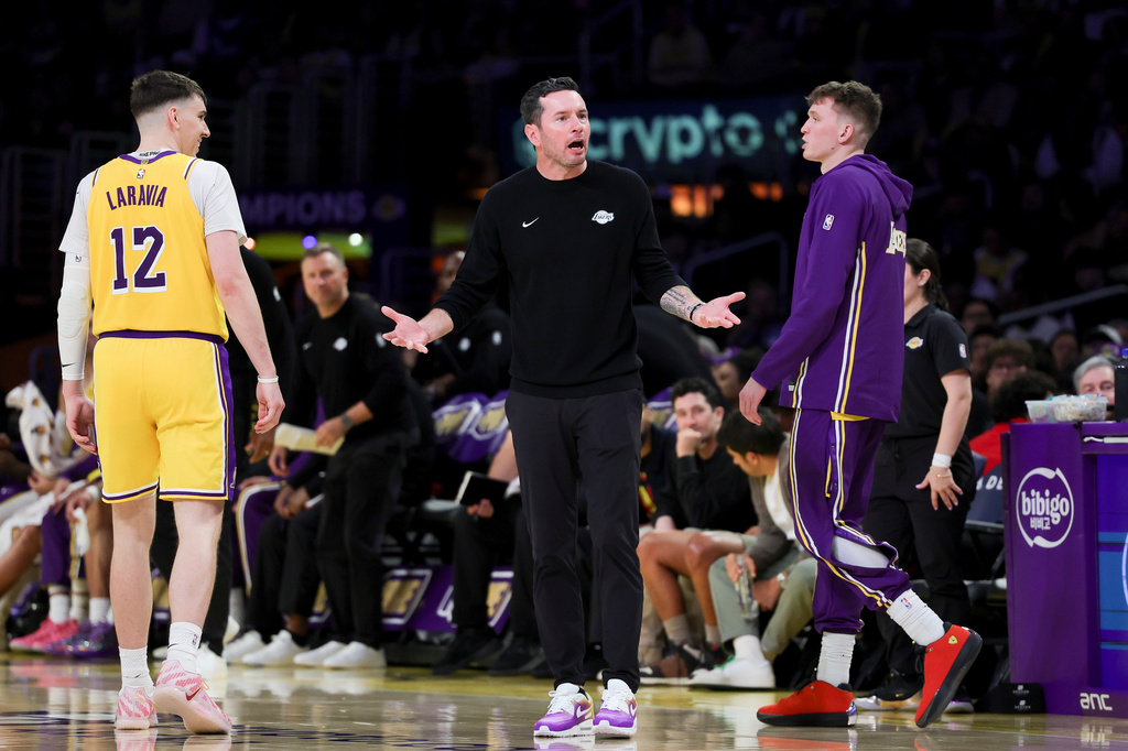 Los Angeles Lakers head coach JJ Redick, center, reacts near forwards Jake LaRavia, left, and Dalton Knecht during the second half of an NBA basketball game Monday, March 30, 2026, in Los Angeles. (AP Photo/Ryan Sun)