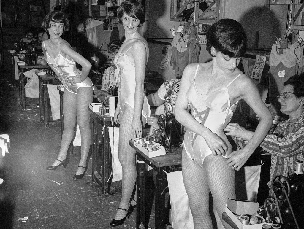 FILE — Rockettes Louise Thompson of Long Beach, Calif., from left, Judy Little of Camden, N.J., and Joyce Hector of West Orange, N.J., are fitted for costumes for a new show in the Radio City Music Hall's costuming department, April 5, 1966, in New York. (AP Photo/Anthony Camerano, File)