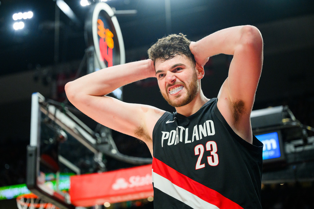 Portland Trail Blazers center Donovan Clingan (23) reacts after being fouled during the second half of an NBA basketball game against the Detroit Pistons, Monday, Dec. 22, 2025, in Portland, Ore. (AP Photo/Molly J. Smith)
