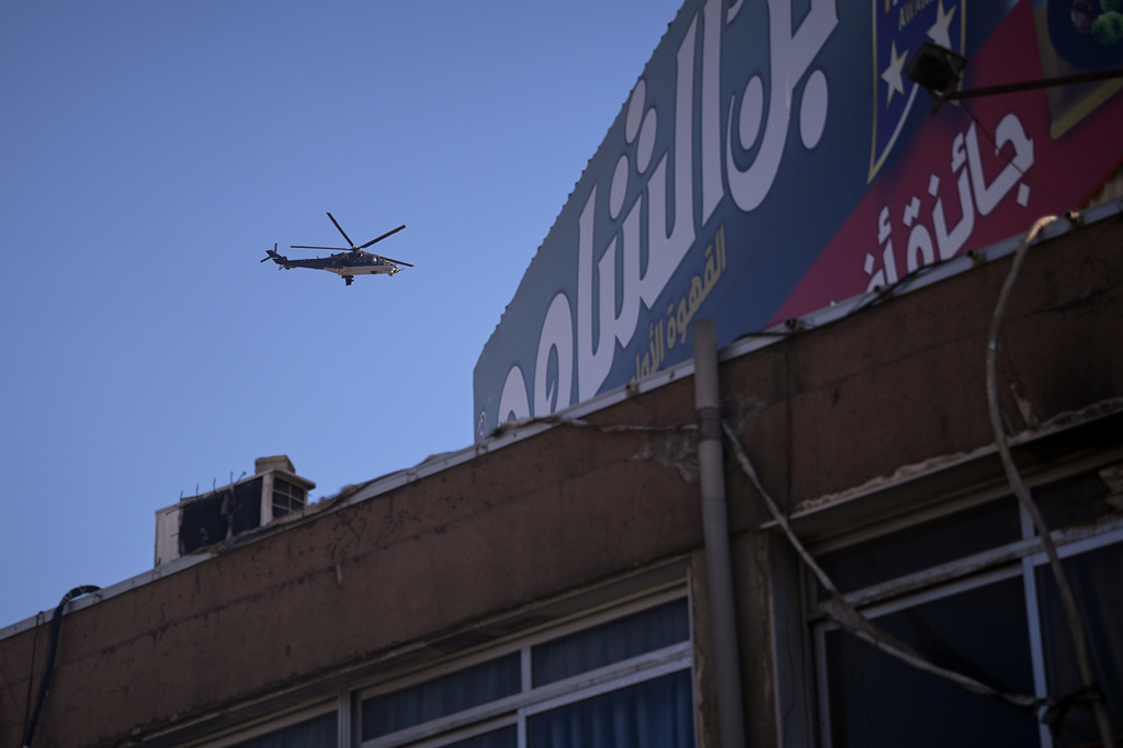 A French helicopter escorts the French presidential delegation over the area where two explosions rocked the neighborhood earlier while Syrian President Ahmad al-Sharaa was meeting French President Emmanuel Macron at the presidential palace, in Damascus, Syria, Tuesday, July 7, 2026. (AP Photo/Omar Albam)