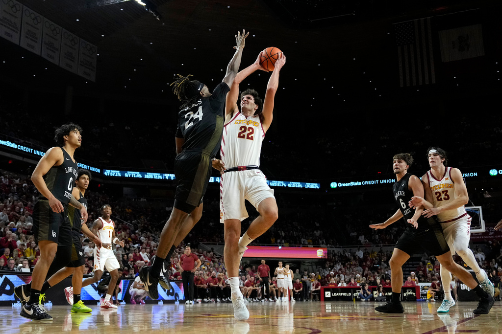 Iowa State forward Milan Momcilovic (22) looks to shoot over Long Beach State guard Christian Jones (24) during the first half of an NCAA college basketball game, Sunday, Dec. 21, 2025, in Ames, Iowa. (AP Photo/Charlie Neibergall)