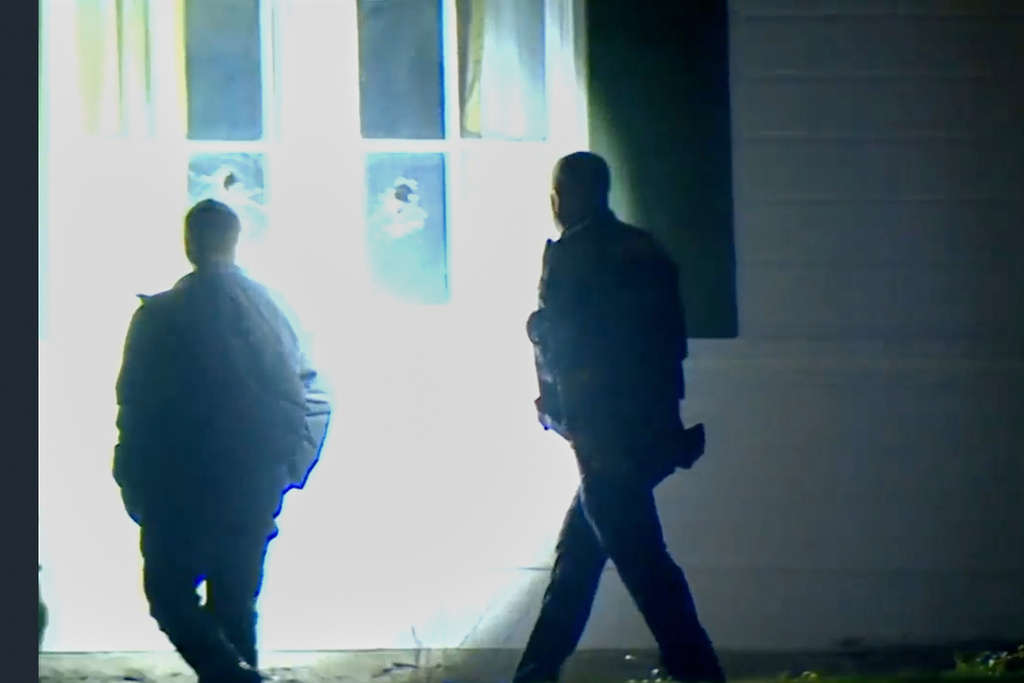 In this image taken from WCPO 9 News video shows officials inspecting broken windows and other property damage at Vice President JD Vance's Ohio home in eastern Cincinnati, Ohio, Monday, Jan. 5, 2026. (WCPO 9 News via AP)