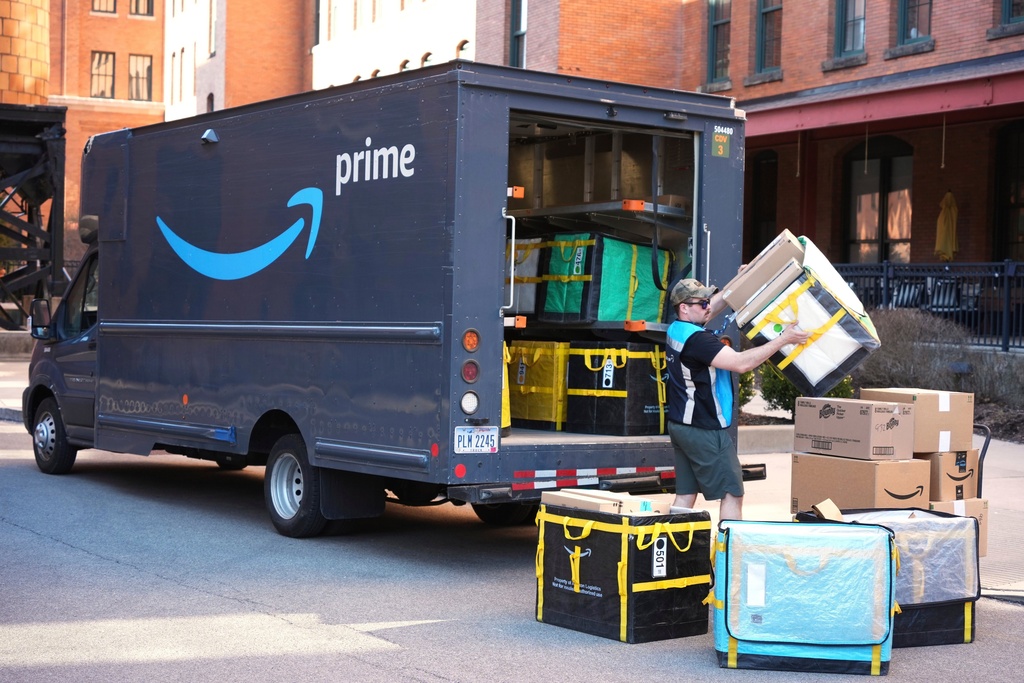 FILE - An Amazon Prime driver makes a delivery outside an apartment building in Pittsburgh, March 10, 2025. (AP Photo/Gene J. Puskar, File)