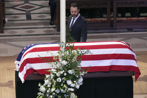 Jason Carter walks past the casket of his grandfather, former President Jimmy Carter, during a state funeral service at Washington National Cathedral in Washington, Thursday, Jan. 9, 2025. (AP Photo/Jacquelyn Martin) Jason Carter walks past the casket of his grandfather, former President Jimmy Carter, during a state funeral service at Washington National Cathedral in Washington, Thursday, Jan. 9, 2025. (AP Photo/Jacquelyn Martin)