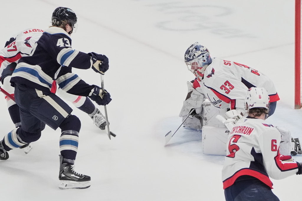 Columbus Blue Jackets left wing Danton Heinen (43) shoots on Washington Capitals goaltender Clay Stevenson (33) in the first period of an NHL hockey game Tuesday, April 14, 2026, in Columbus, Ohio. (AP Photo/Sue Ogrocki)