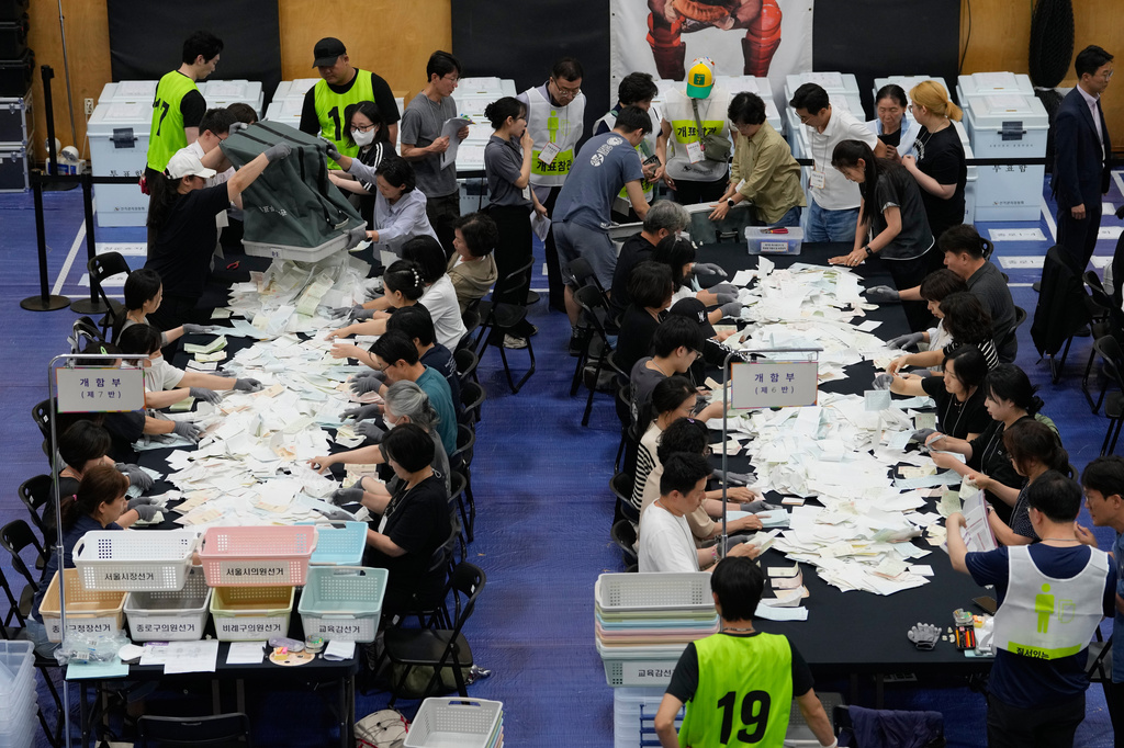Election Commission officials prepare ballots for counting at the local elections at a gymnasium in Seoul, South Korea, Wednesday, June 3, 2026. (AP Photo/Ahn Young-joon)