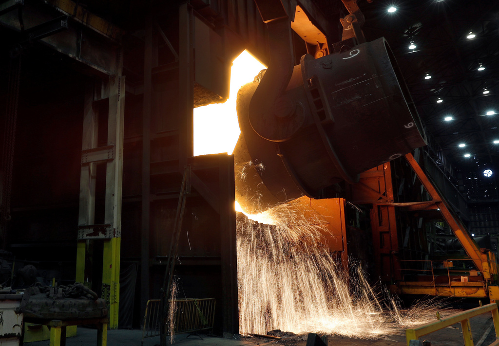 FILE - Molten iron is poured into a vessel as part of the process of producing steel at the U.S. Steel Granite City Works facility, Thursday, June 28, 2018, in Granite City, Ill. (AP Photo/Jeff Roberson, File)