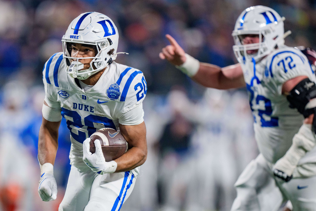 Duke running back Nate Sheppard (20) runs for a touchdown in the first half of the Atlantic Coast Conference championship NCAA college football game against Virginia, Saturday, Dec. 6, 2025, in Charlotte, N.C. (AP Photo/Jacob Kupferman)