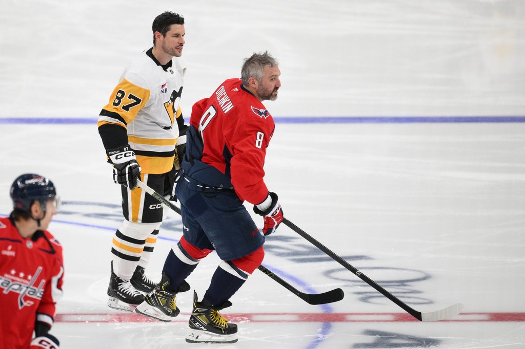 Pittsburgh Penguins center Sidney Crosby (87) meets with Washington Capitals left wing Alex Ovechkin (8) during warmups before an NHL hockey game, Sunday, April 12, 2026, in Washington. (AP Photo/Nick Wass)