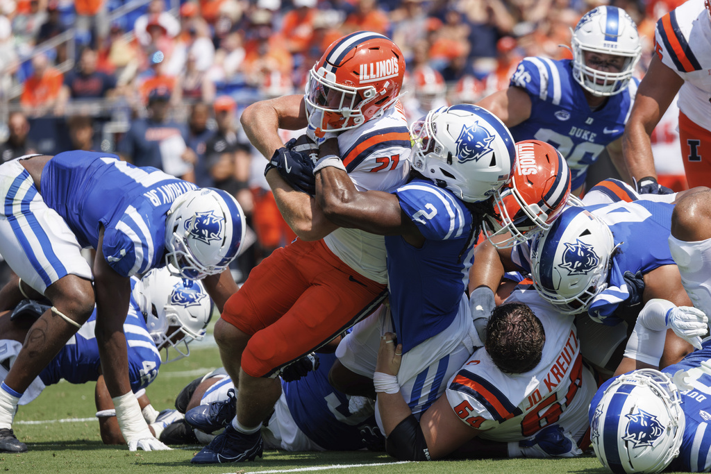 Illinois Corey Rashad (27) is tackled by Duke's Jaiden Francois (2) during the first half of an NCAA college football game in Durham, N.C., Saturday, Sept. 6, 2025. (AP Photo/Ben McKeown)