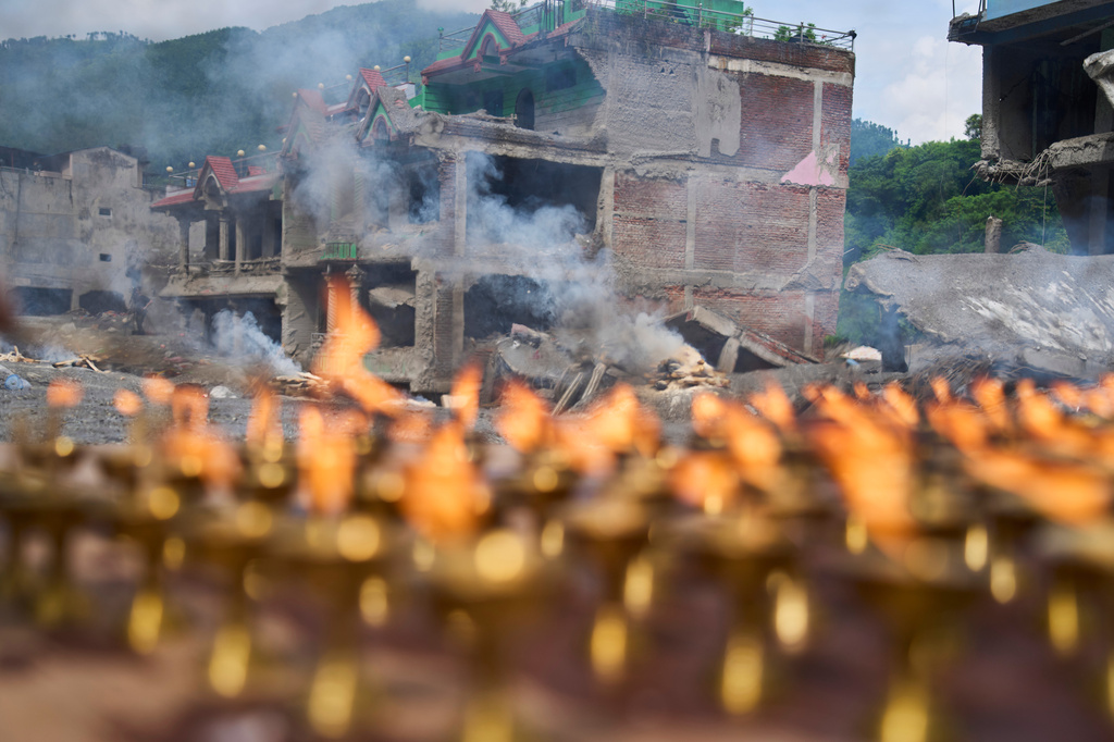 Lamps burn as Buddhist monks perform rituals and prayers for victims of the recent flash floods in the Dhunge area of district Nuwakot, Nepal, Monday, Sept. 7, 2026. (AP Photo/Niranjan Shrestha)