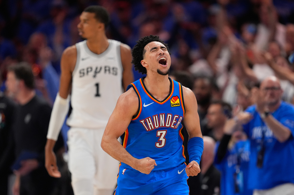 Oklahoma City Thunder guard Jared McCain (3) celebrates after making a 3-pointer during the second half of Game 2 in the Western Conference finals NBA basketball playoffs series against the San Antonio Spurs Wednesday, May 20, 2026, in Oklahoma City. (AP Photo/Tony Gutierrez)