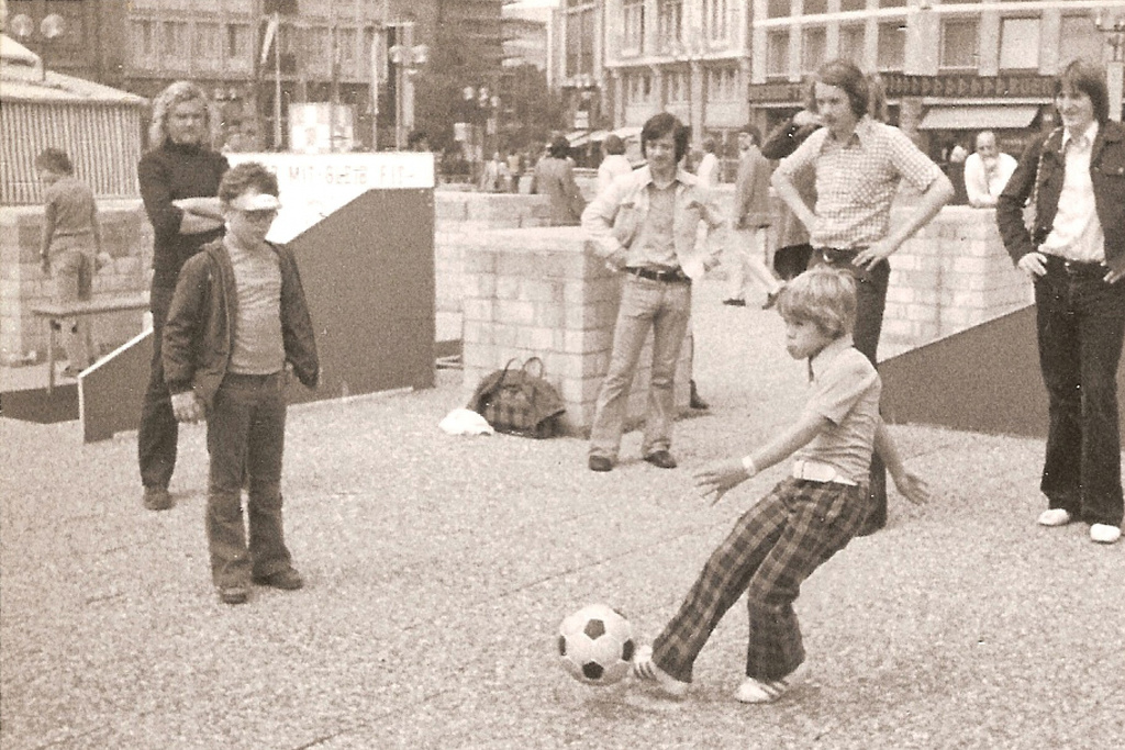 In this photo provided by the Hunt family, Clark Hunt kicks a ball at a World Cup fan plaza in Dusseldorf, Germany, during the 1974 soccer tournament. (Hunt Family via AP)