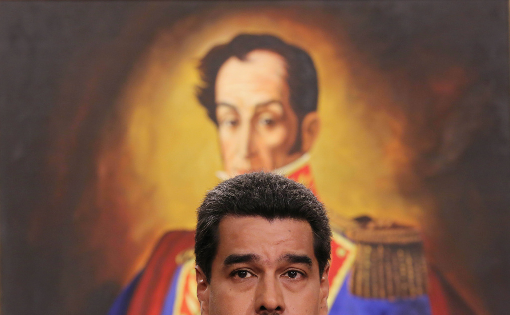 FILE - Venezuela's President Nicolas Maduro, backdropped by a painting of independence hero Simon Bolivar, speaks during a press conference at the Miraflores Presidential Palace in Caracas, Venezuela. (AP Photo/Ariana Cubillos, File)