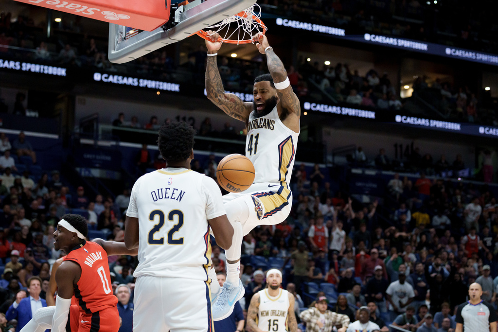 New Orleans Pelicans guard Saddiq Bey (41) dunks against Houston Rockets guard Aaron Holiday (0) near Pelicans center Derik Queen (22) during the second half of an NBA basketball game in New Orleans, Thursday, Dec. 18, 2025. (AP Photo/Matthew Hinton)
