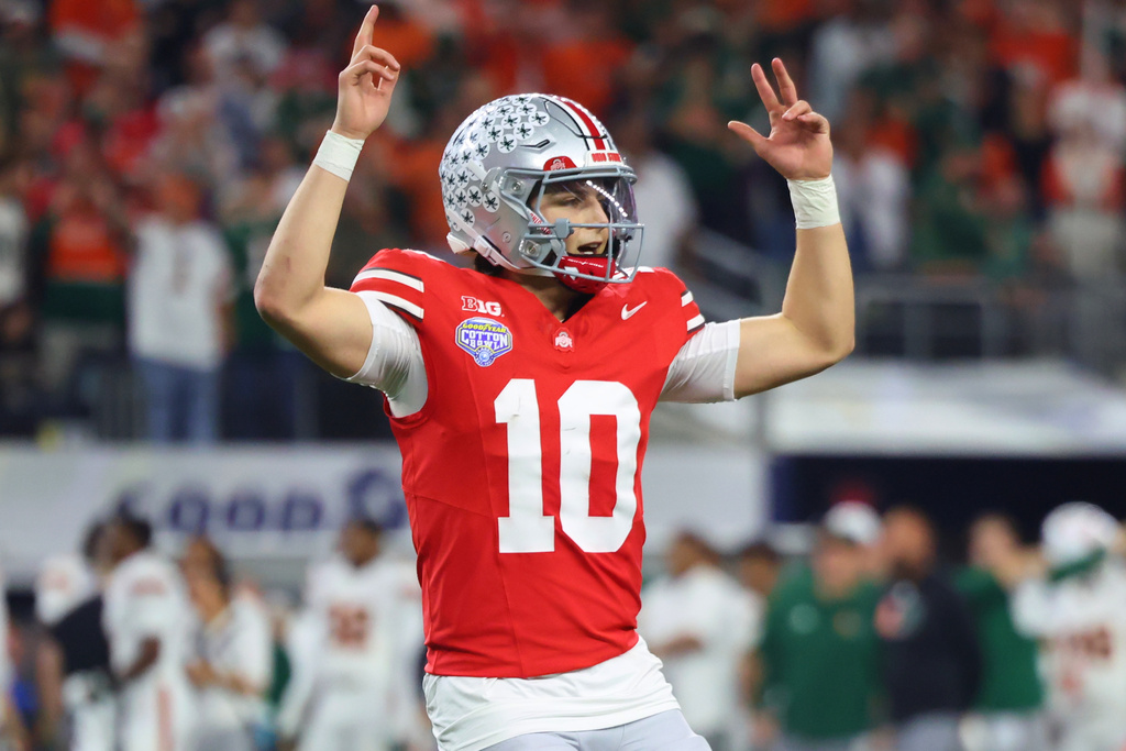 Ohio State quarterback Julian Sayin reacts after throwing a touchdown pass against Miami during the second half of the Cotton Bowl College Football Playoff quarterfinal game Wednesday, Dec. 31, 2025, in Arlington, Texas. (AP Photo/Gareth Patterson)