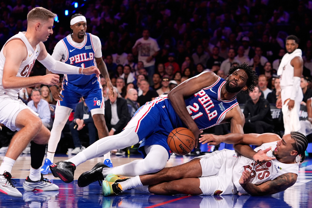 Philadelphia 76ers' Joel Embiid (21) collides with Cleveland Cavaliers' Jaylon Tyson (20) during the second half of an NBA basketball game Thursday, Oct. 22, 2026, in Philadelphia. (AP Photo/Matt Slocum)