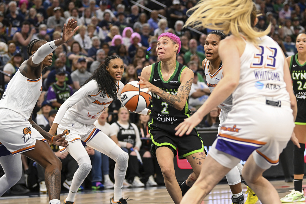 Minnesota Lynx guard Natisha Hiedeman (2) drives to the basket past a group of Phoenix Mercury defenders during the second half of Game 1 of a WNBA basketball playoff semifinals series Sunday, Sept. 21, 2025, in Minneapolis. (AP Photo/Craig Lassig)