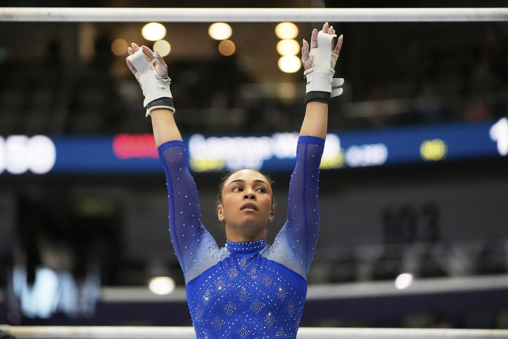 Hezly Rivera of WOGA reacts after competing on the uneven bars during the senior women's finals of the U.S. Gymnastics Championships in New Orleans, Sunday, Aug. 10, 2025. (AP Photo/Gerald Herbert)