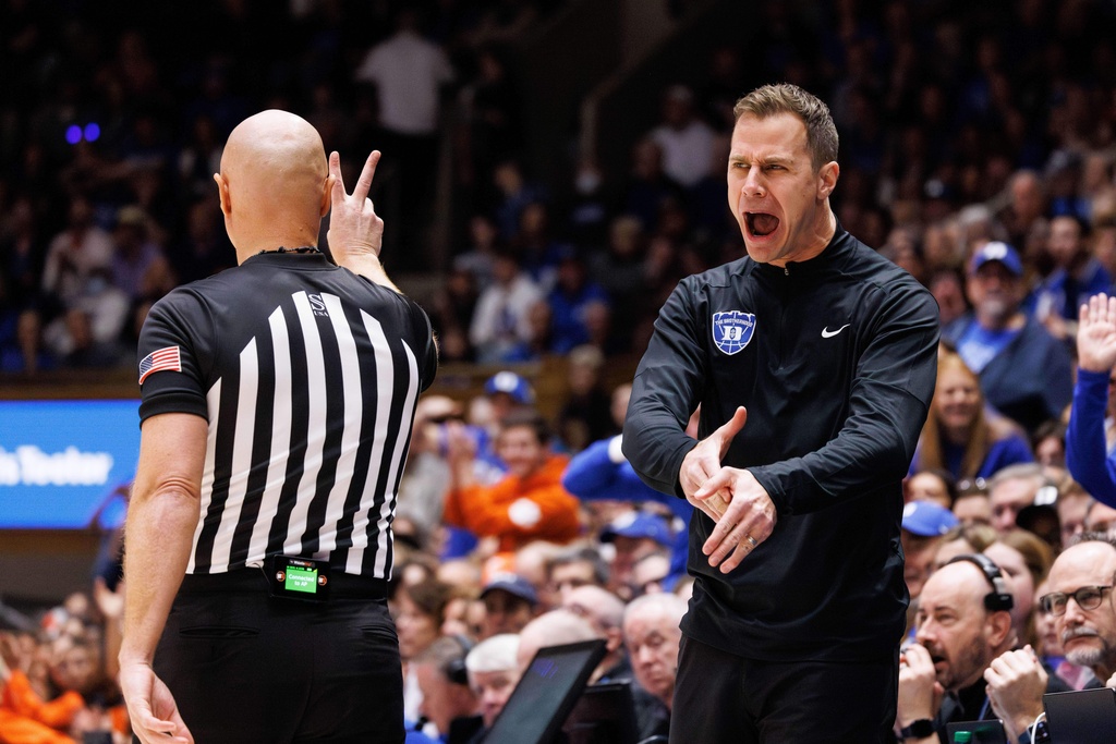 Duke head coach Jon Scheyer, right, reacts to a call during the first half of an NCAA college basketball game against Clemson in Durham, N.C., Saturday, Feb. 14, 2026. (AP Photo/Ben McKeown)