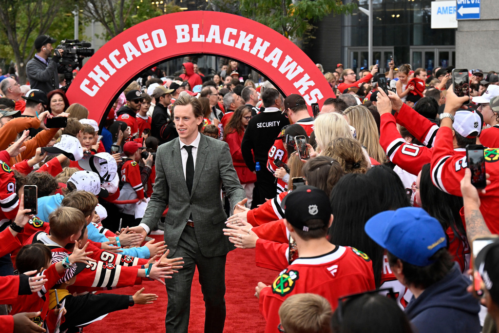 Chicago Blackhawks defenseman Connor Murphy greets fans on a red carpet before an NHL hockey game against the Montreal Canadiens, Saturday, Oct. 11, 2025, in Chicago. (AP Photo/Matt Marton)