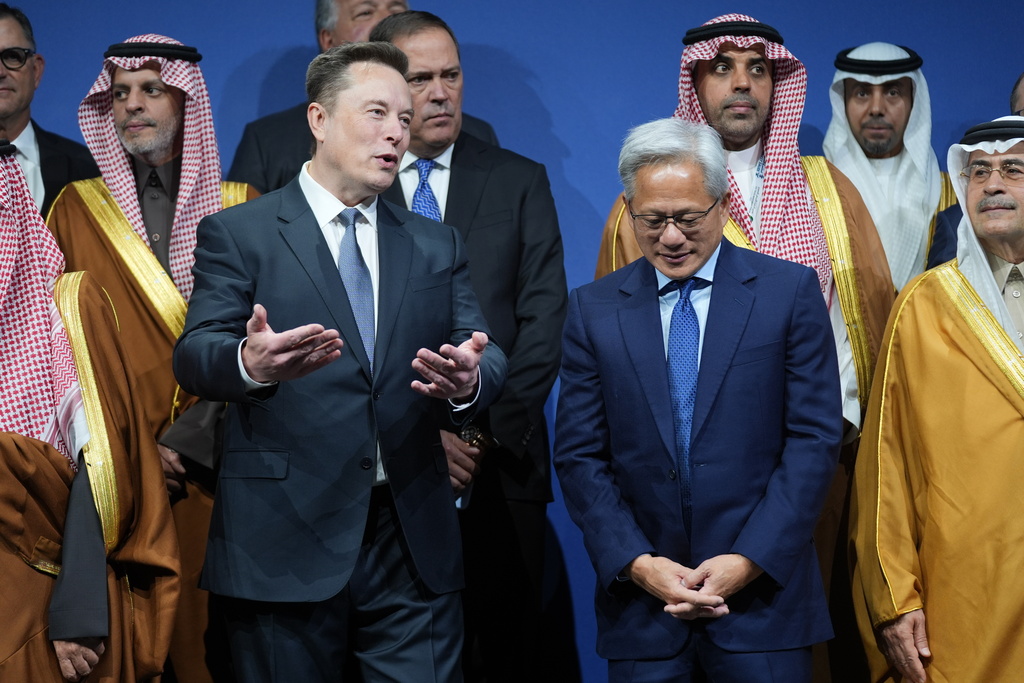 Elon Musk speaks with Nvidia CEO Jensen Huang, as they attend the Saudi Investment Forum at the Kennedy Center, Wednesday, Nov. 19, 2025, in Washington. (AP Photo/Evan Vucci)