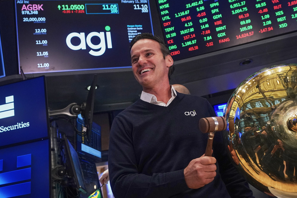 AGI Inc Founder, Executive Chairman & CEO Marciano Testa rings a ceremonial bell on the floor of the New York Stock Exchange as his company's IPO begins trading, Wednesday, Feb. 11, 2026. (AP Photo/Richard Drew)