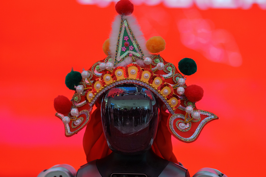 A humanoid robot wearing a traditional headdress is displayed during a media preview of a robotic temple fair ahead of Lunar New Year in Beijing, China, Friday, Feb. 13, 2026. (AP Photo/Vincent Thian)