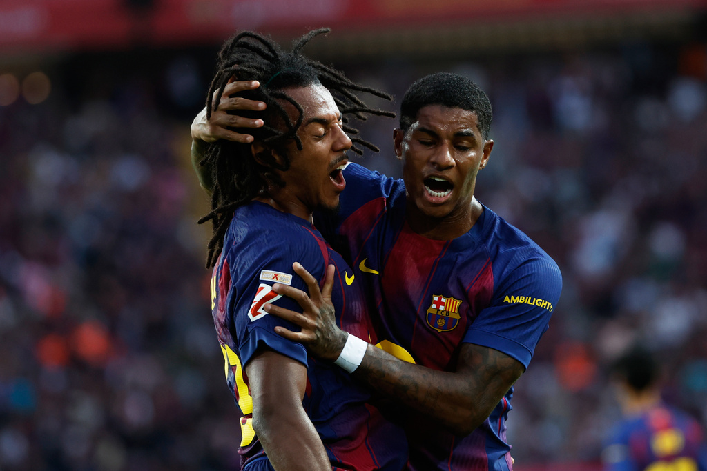 Barcelona's Marcus Rashford, right, congrats Barcelona's Jules Kounde after their side first goal during a Spanish La Liga soccer match between FC Barcelona and Real Sociedad at the Lluis Companys Olympic Stadium in Barcelona, Spain, Sunday, Sept. 28, 2025. (AP Photo/Joan Monfort)