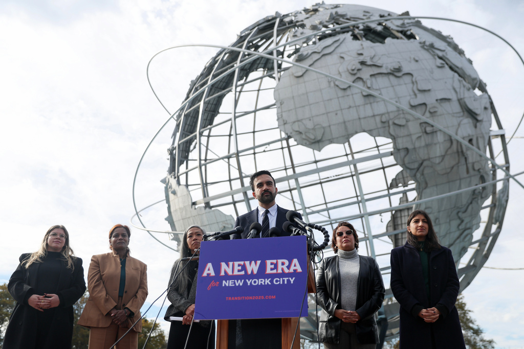 New York City mayor-elect Zohran Mamdani, center, speaks in front of the Unisphere alongside his transition team, from left, Elana Leopold, Melanie Hartzog, Maria Torres-Springer, Grace Bonilla, and Lina Khan, in the Queens borough of New York, Wednesday, Nov. 5, 2025. (AP Photo/Heather Khalifa)