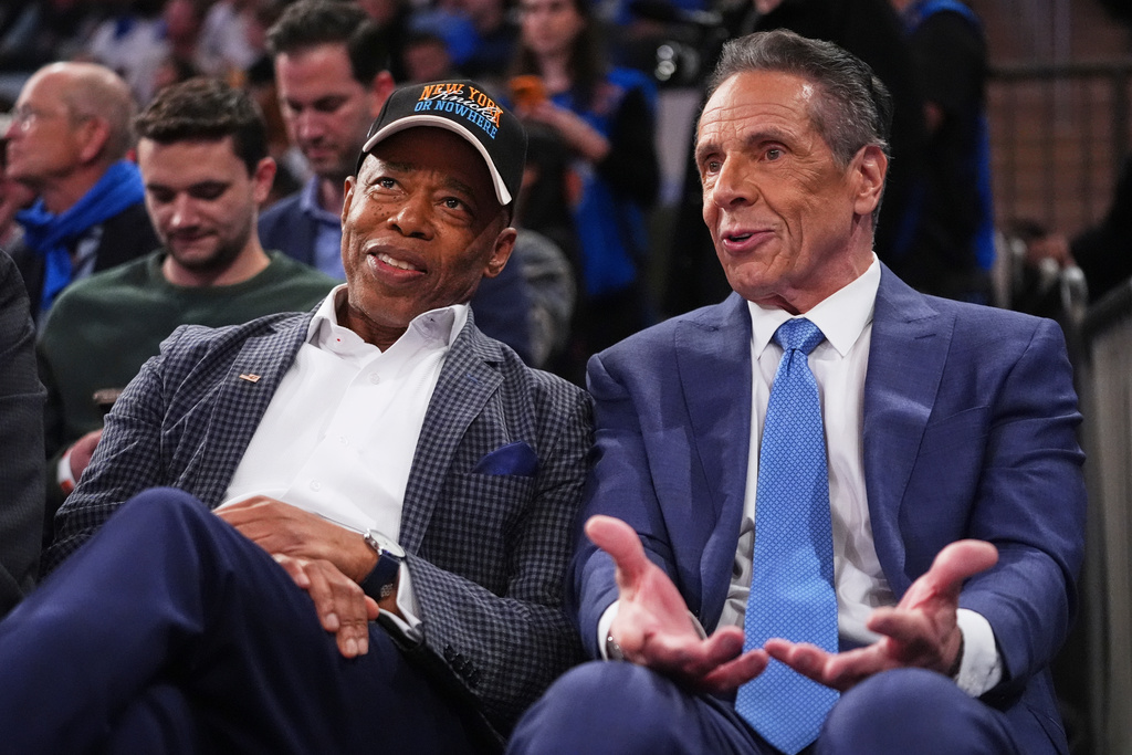 New York City Mayor Eric Adams, left, and Independent candidate former New York Gov. Andrew Cuomo, right, speak during the second half of an NBA basketball game between the New York Knicks and the Cleveland Cavaliers Wednesday, Oct. 22, 2025, at Madison Square Garden in New York. (AP Photo/Frank Franklin II)
