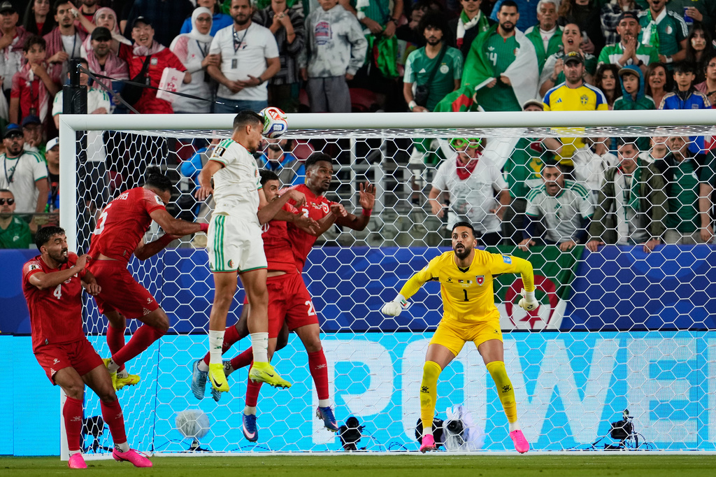 Algeria's Nadhir Benbouali (12) heads the ball to score his side's opening goal during the World Cup Group J soccer match between Jordan and Algeria in Santa Clara, Calif., near San Francisco, Monday, June 22, 2026. (AP Photo/Eugene Hoshiko)