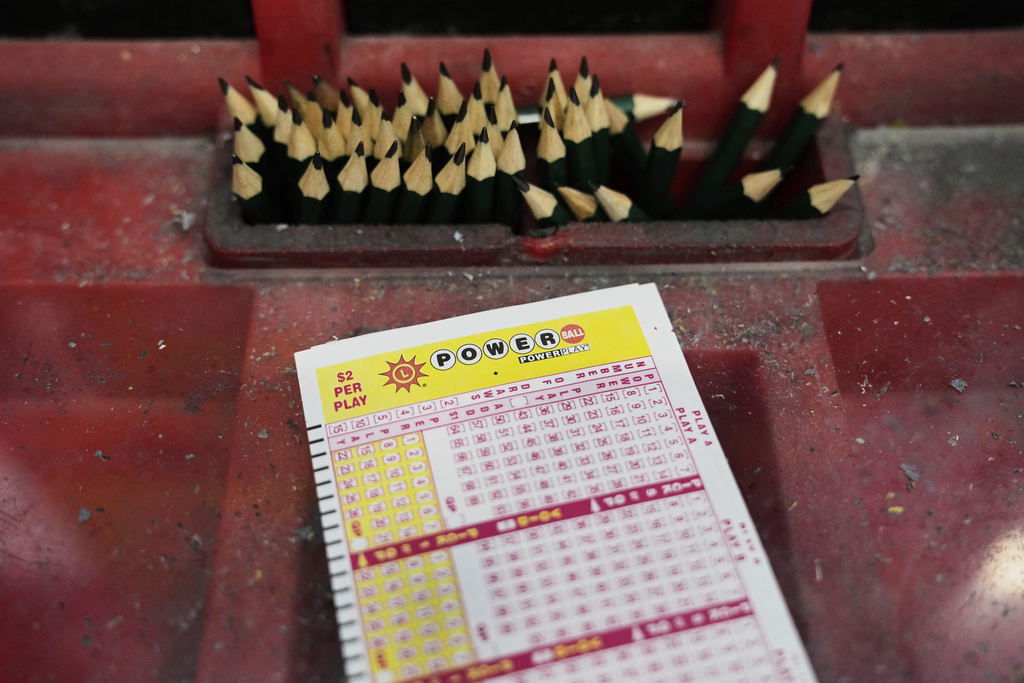 A Powerball play slip sits on the lottery ticket counter at a gas station, Friday, Aug. 29, 2025, in Baltimore. (AP Photo/Stephanie Scarbrough)