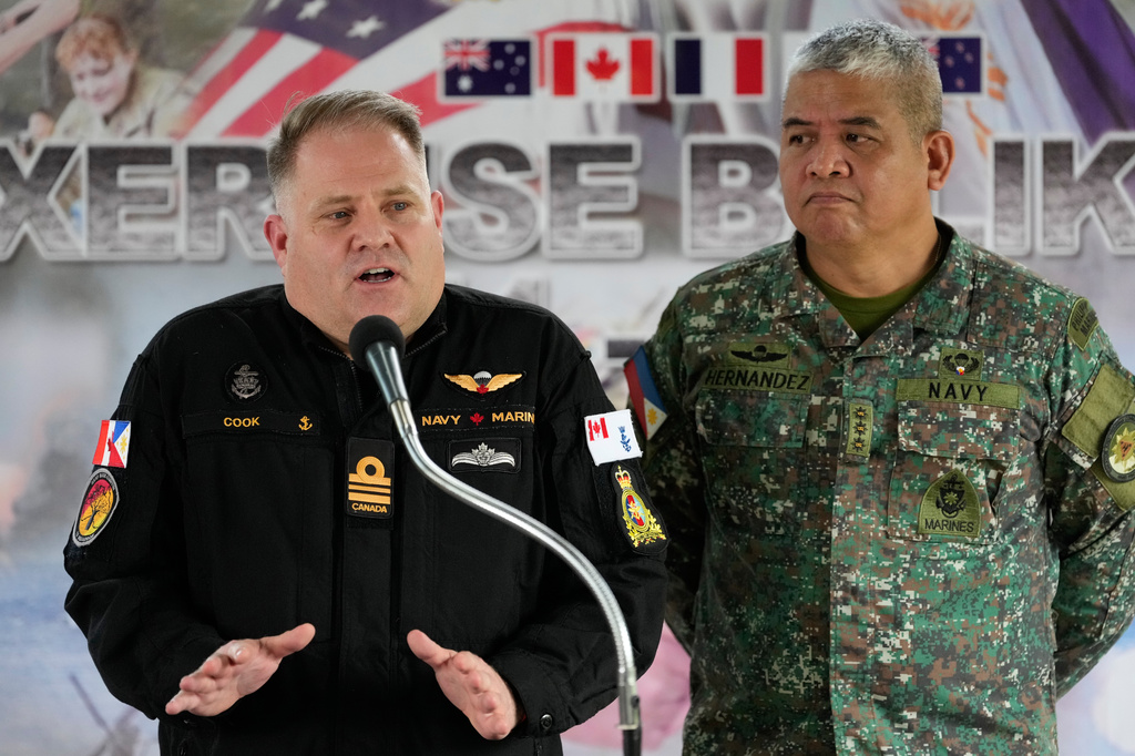 Canada Navy Lt. Commander Craig Cook, left, speaks beside Philippine Navy Col. Dennis Hernandez during a press conference for the upcoming joint military exercise dubbed "Balikatan" or "Shoulder to Shoulder" at Camp Aguinaldo military headquarters on Tuesday, April 14, 2026, in Quezon city, Philippines. (AP Photo/Aaron Favila)